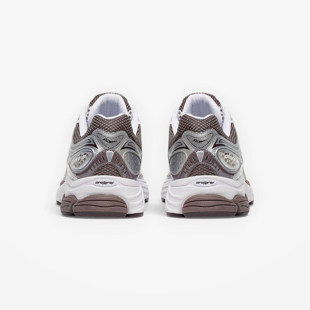 METRO ProGrid Omni 9 retro runner sneakers in white, brown, and silver mesh with synthetic overlays and ProGrid cushioning.