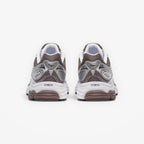METRO ProGrid Omni 9 retro runner sneakers in white, brown, and silver mesh with synthetic overlays and ProGrid cushioning.