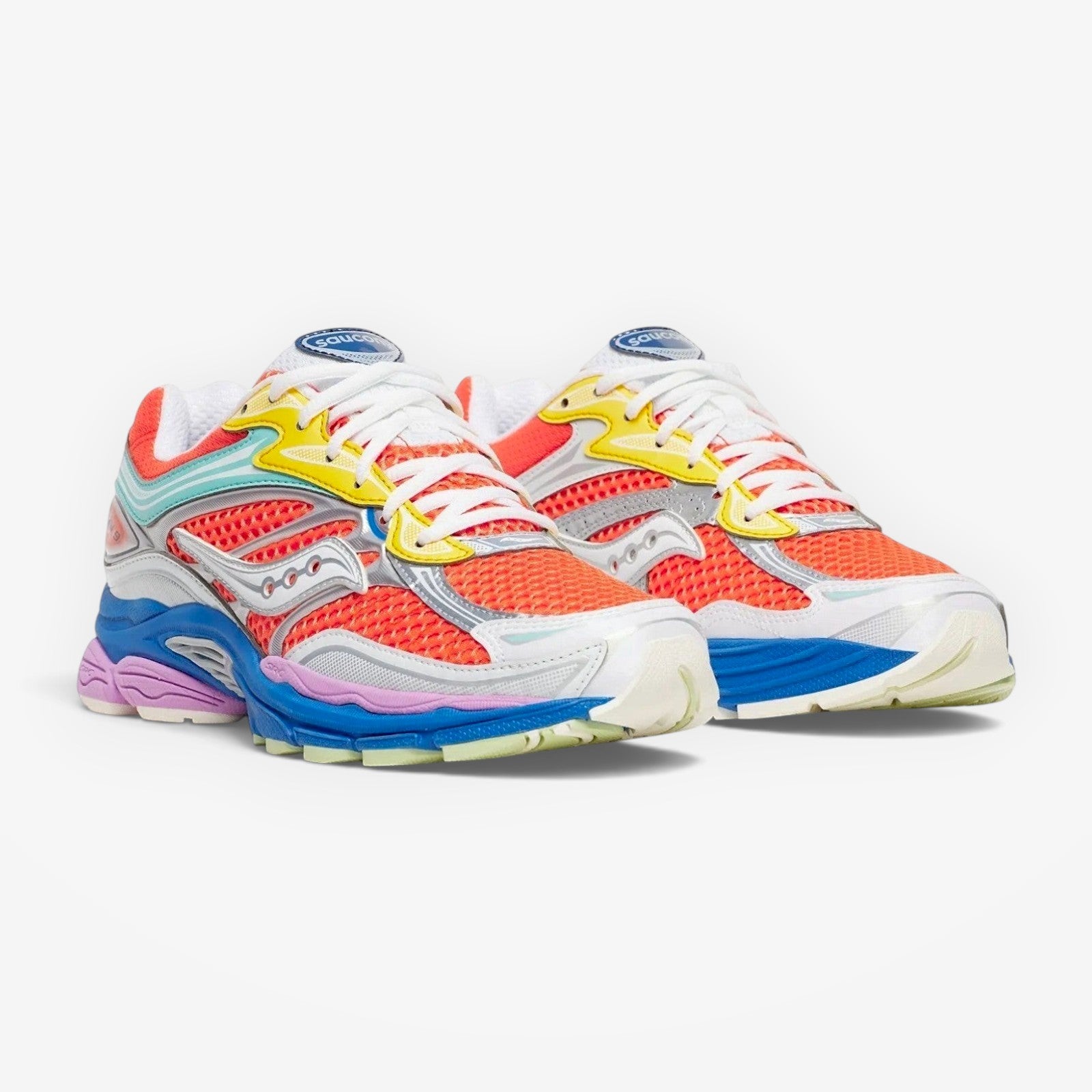 METRO Saucony Progrid Omni 9 retro running sneakers in vibrant orange, yellow, blue, and silver multi-color mesh.