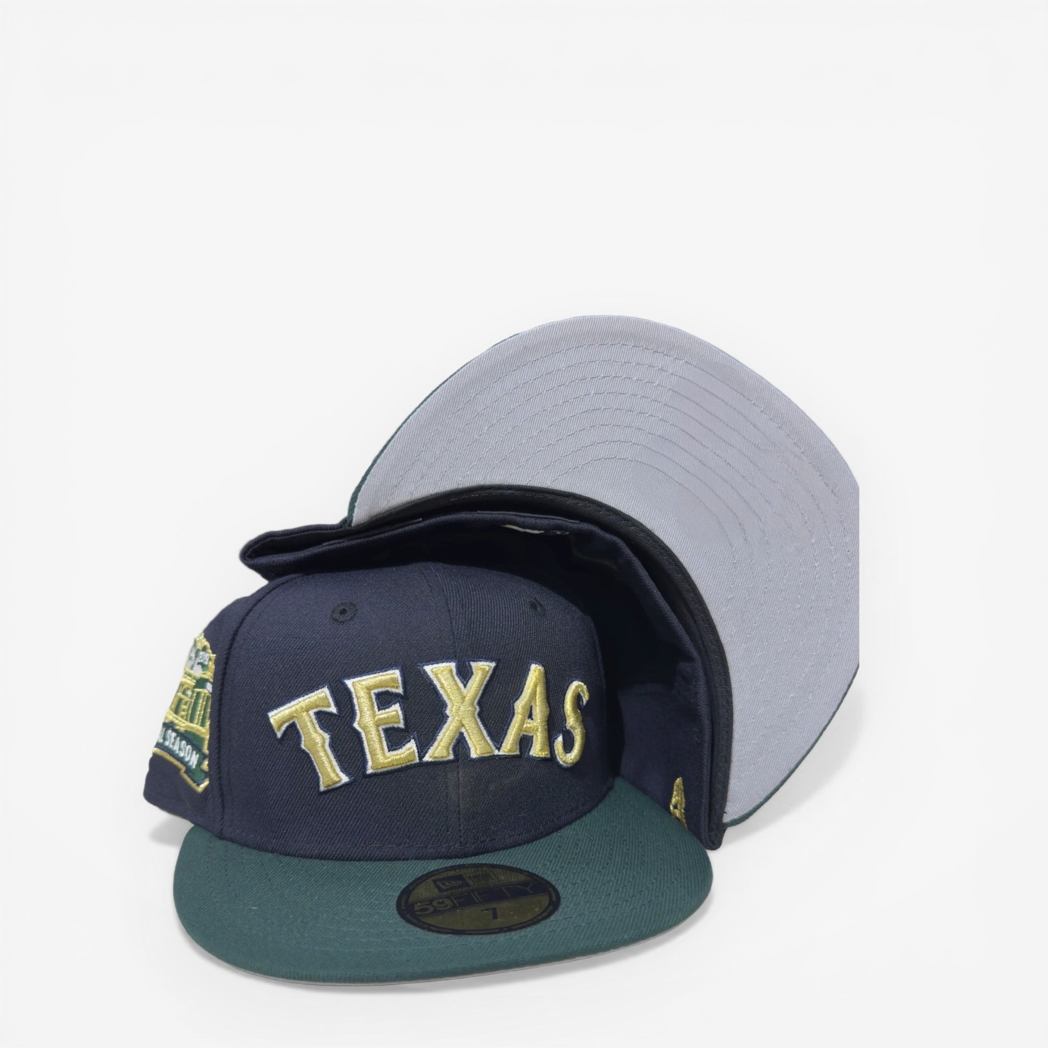 METRO Texas Rangers navy fitted hat with gold "TEXAS" text, green brim, and "Final Season" patch. Grey underbrim.