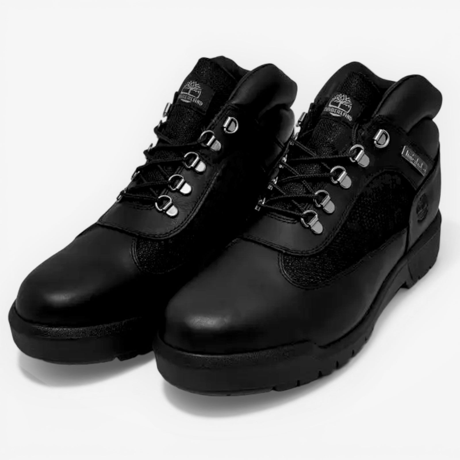 Pair of black leather boots on a light gray background