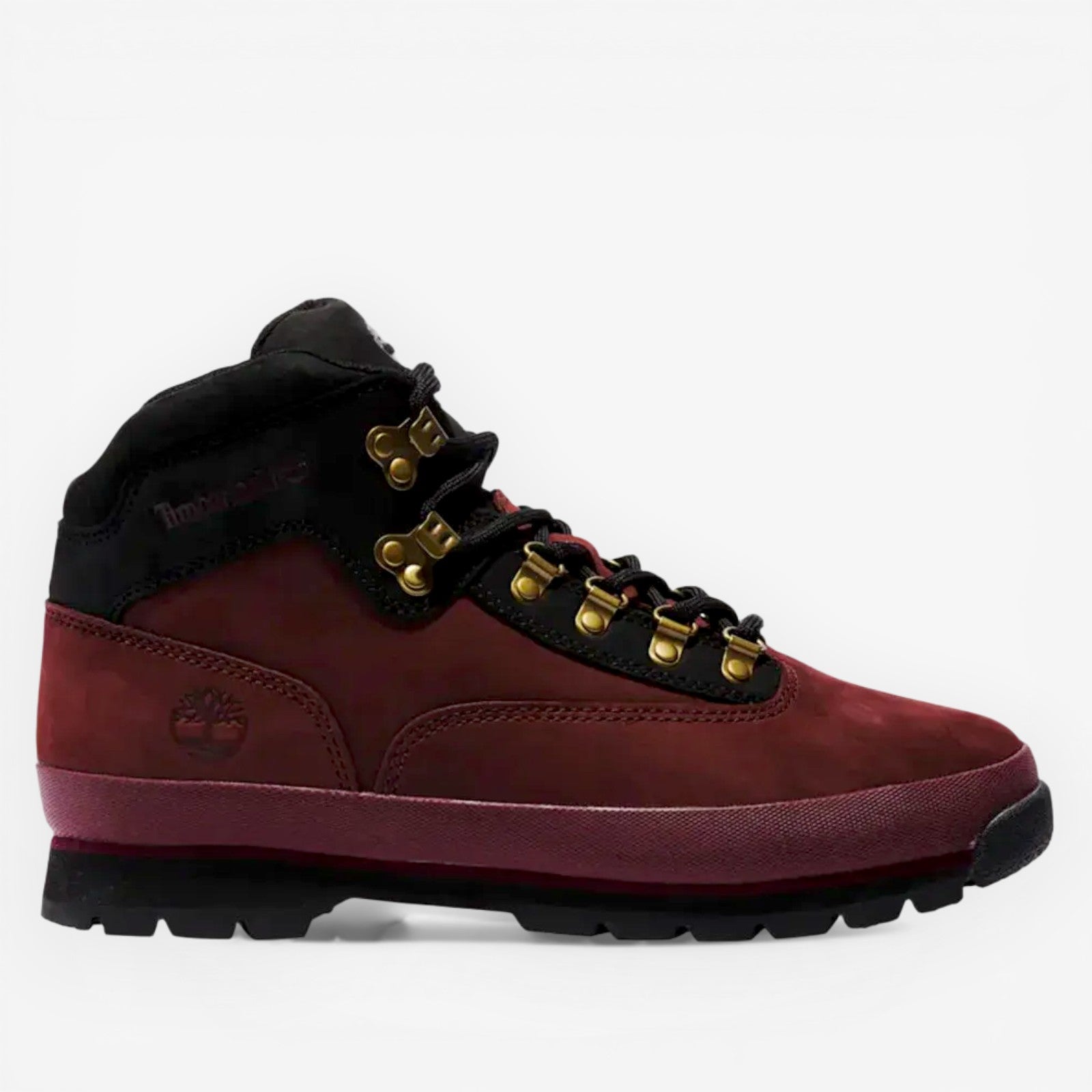 Red and black Timberland boot with gold laces on a white background