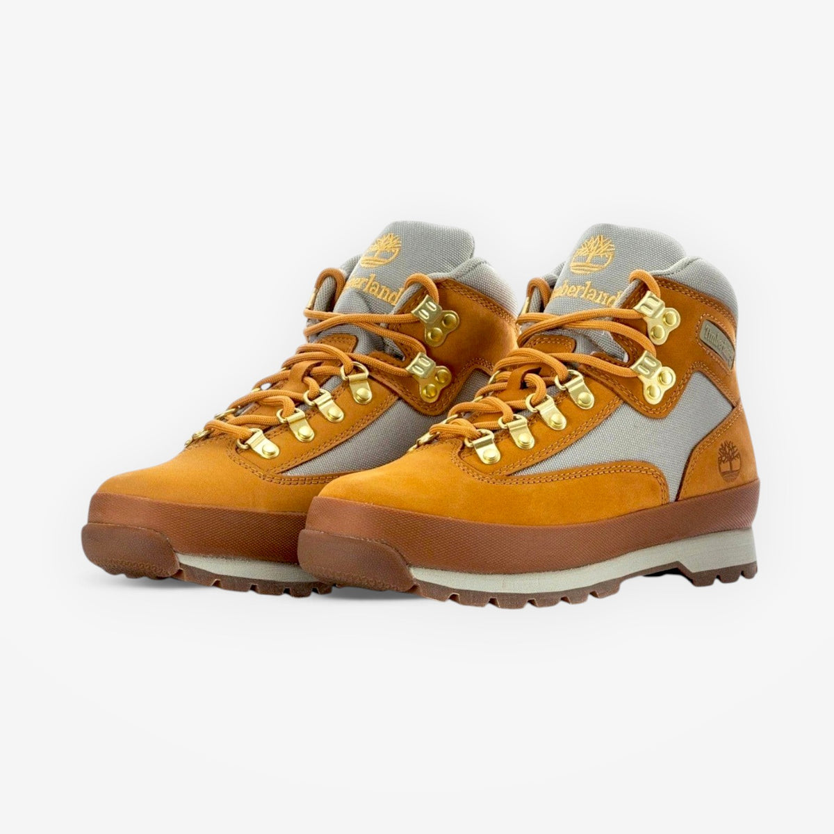 METRO Timberland Euro Hiker Mid boots in wheat leather with grey fabric panels, gold hardware, and rubber lug soles.