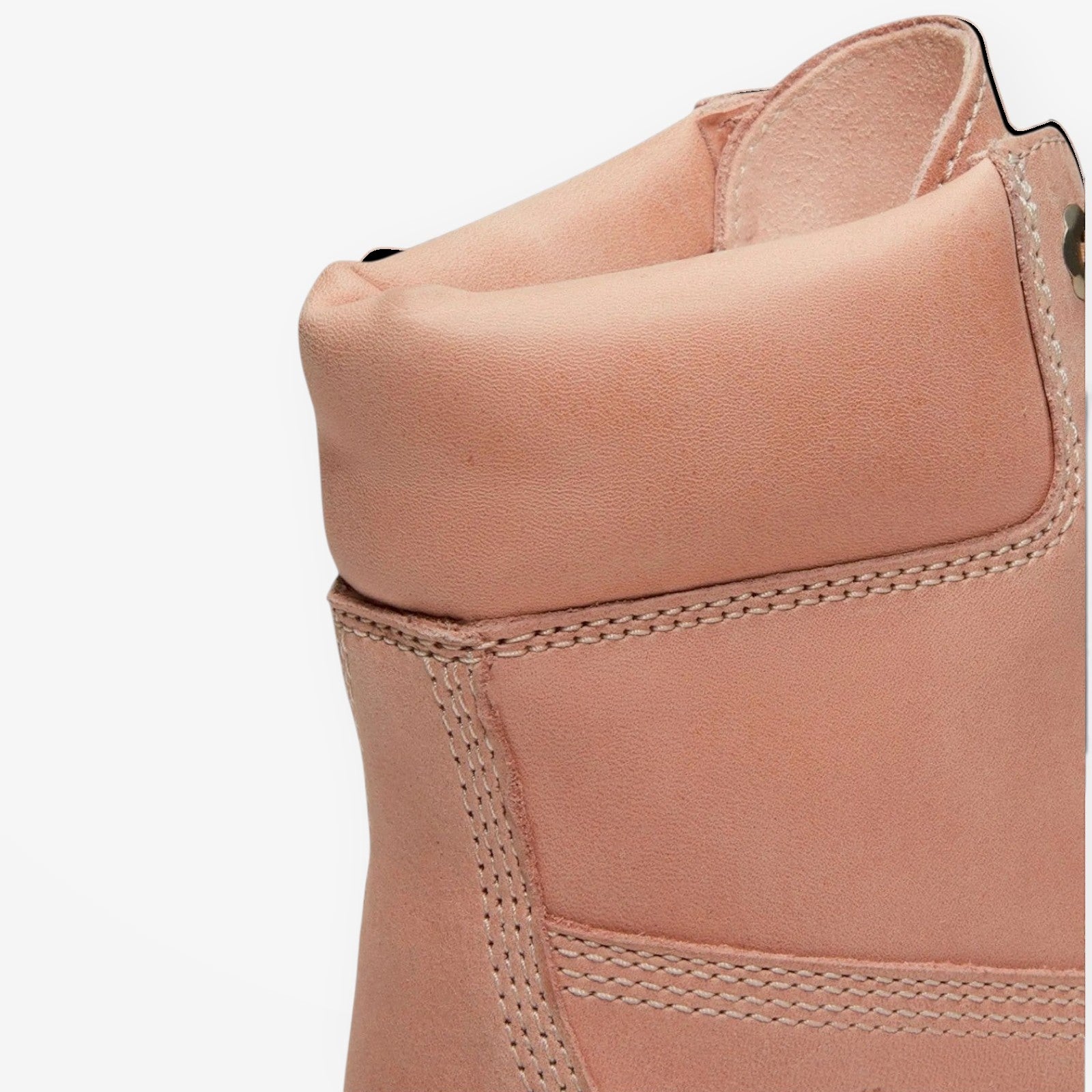 Close-up of a light pink METRO Timberland premium 6-inch boot showing the padded leather collar and stitching detail.