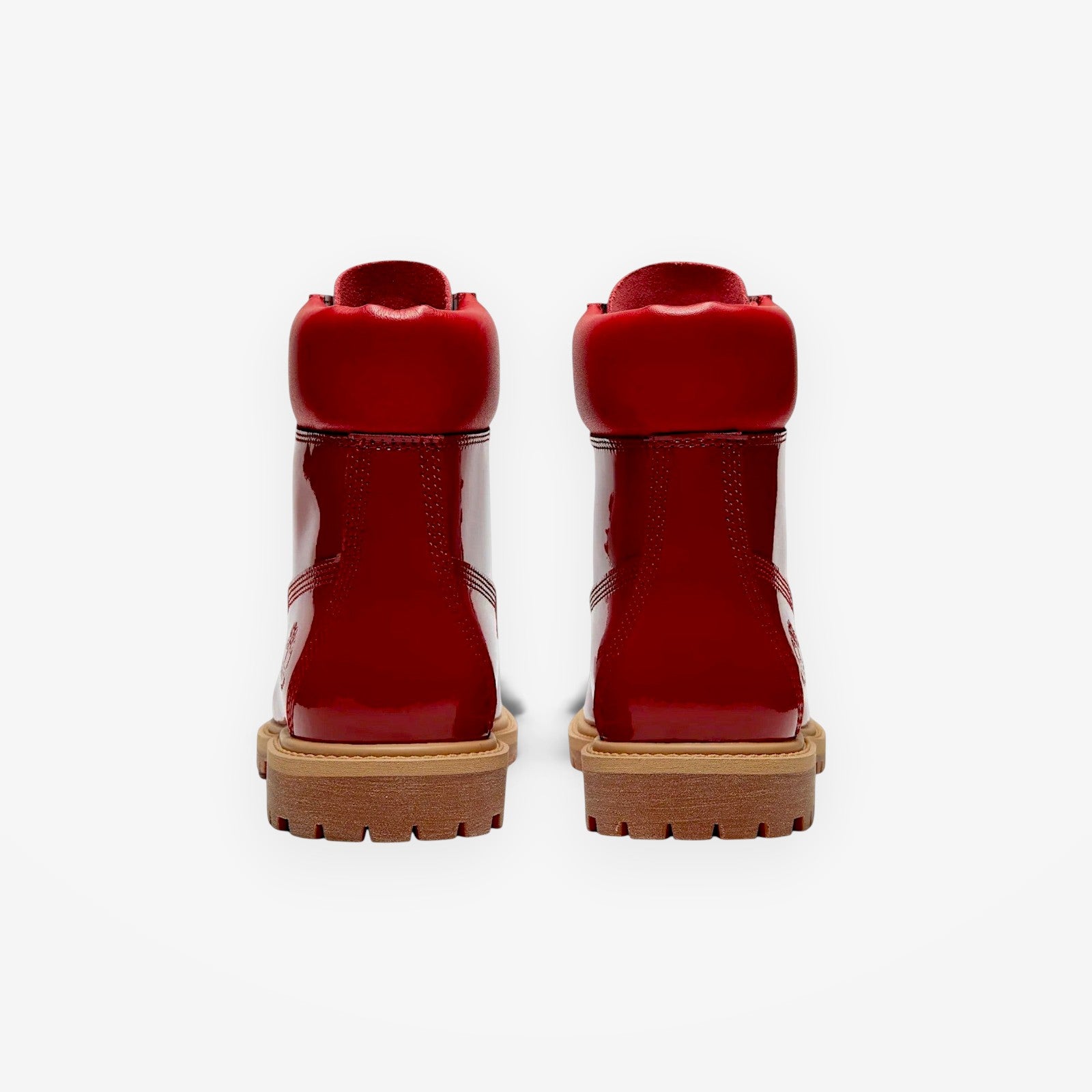 METRO Timberland women's red patent leather 6-inch waterproof boots, back view showing rubber lug soles and padded collars.
