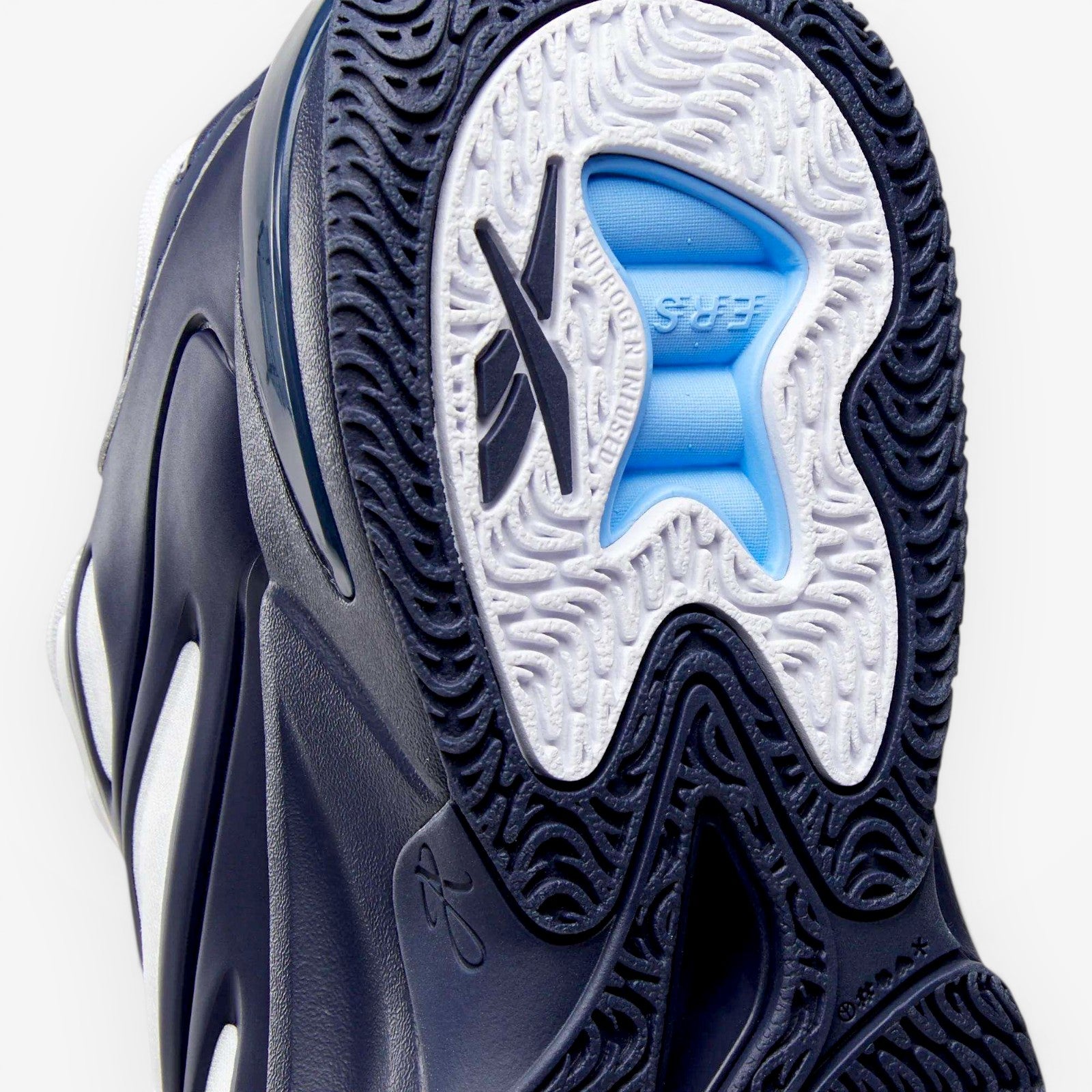 METRO Reebok Angel Reese 1 basketball shoes in navy, white, and peri blue with performance cushioning and rubber outsole.