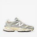 New Balance grey suede and mesh sneaker, athletic footwear, side profile on black background