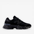 Black New Balance sneaker with chunky sole, mesh and suede details, side logo visible