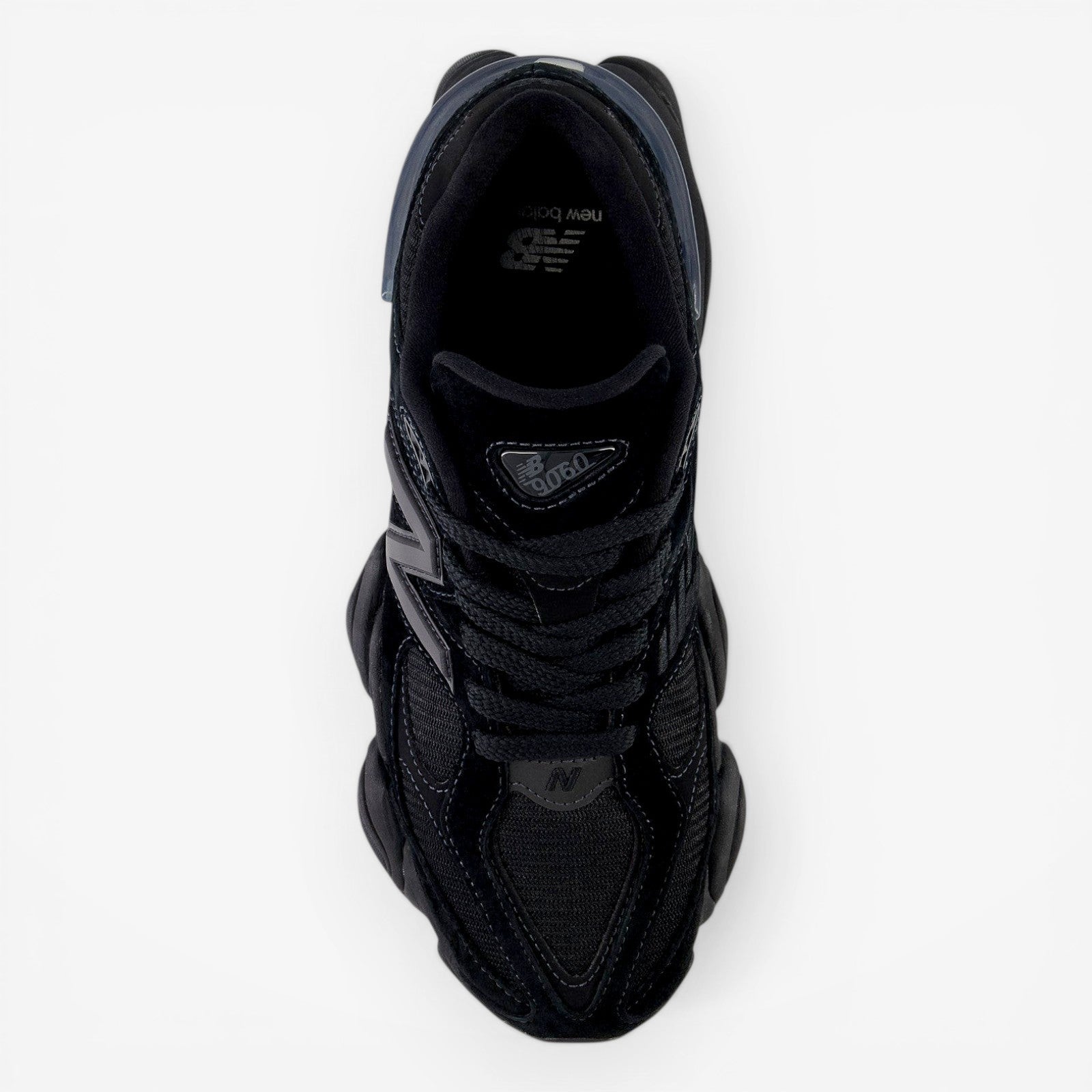 Top view of black New Balance sneaker with mesh and suede details, perfect for footwear lovers.