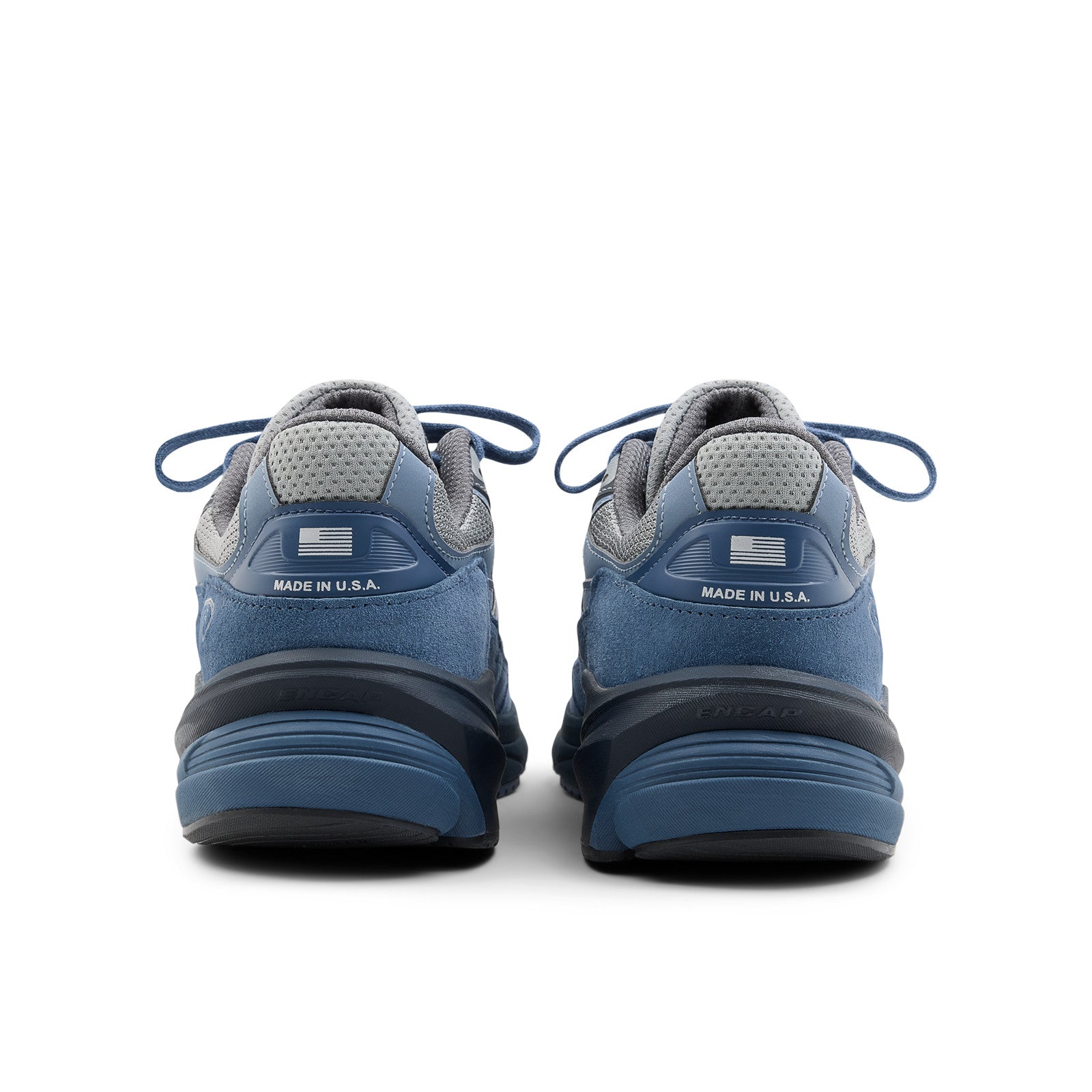 Back view of blue and grey New Balance sneakers, suede and mesh footwear, Made in USA.