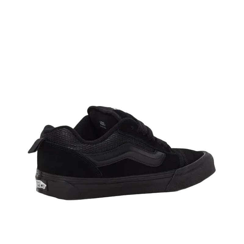 Black low-top sneaker with textured panels, suitable for new balance, asics, footwear, sneakers